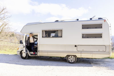 Woman standing on doorstep of motor home