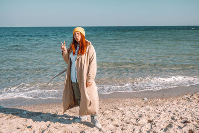 Young woman standing at beach