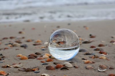 Crystal ball on sand at beach