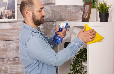 Man cleaning rack at home