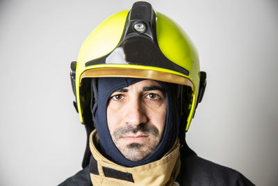 Portrait of man wearing hat against gray background