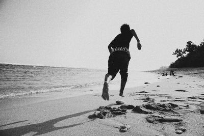 Man standing on beach against sky