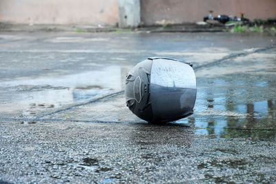 Motorcycle helmet for traffic lying on wet and sliping road floor. accident and protection concept.