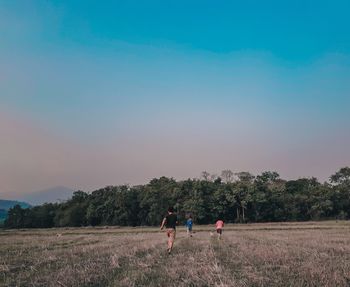 People on field against clear sky