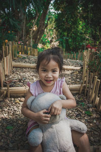 Portrait of a smiling girl sitting outdoors
