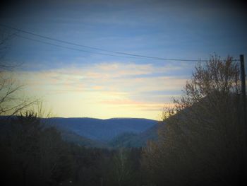 Scenic view of silhouette mountains against sky at sunset