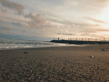 Scenic view of beach against sky during sunset
