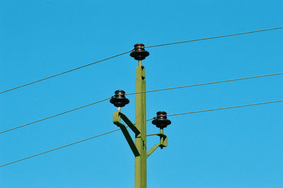 Low angle view of electric  wire against blue sky