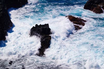 Waves splashing on rocks at shore