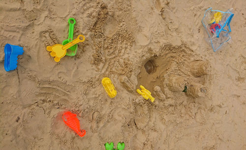 High angle view of yellow toy on beach