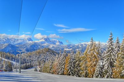 Scenic view of snowcapped mountains against blue sky