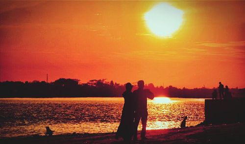 Silhouette of people at sunset