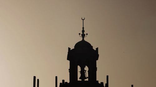 Low angle view of silhouette temple against sky during sunset