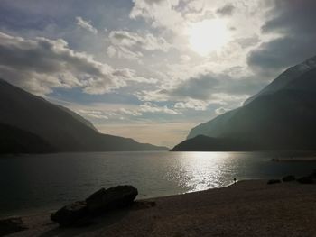 Scenic view of sea and mountains against sky