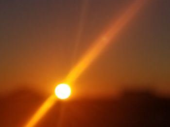 Close-up of illuminated lights against sky during sunset