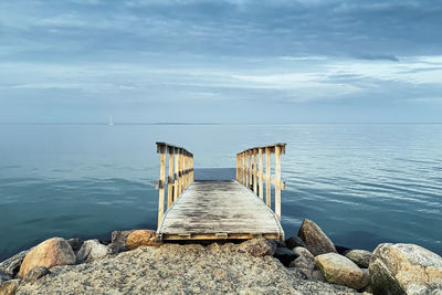 Pier over sea against sky