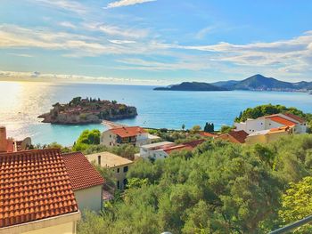 High angle view of townscape by sea against sky