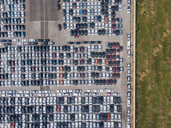 High angle view of cars in parking lot by building