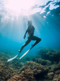 Low angle view of man swimming in sea