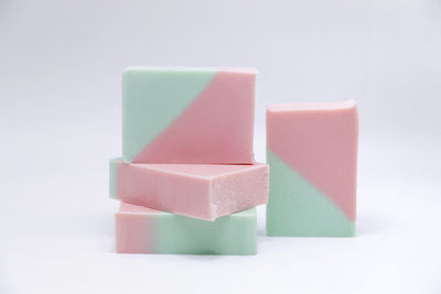 Close-up of soaps on white background