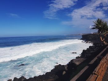 Scenic view of sea against blue sky