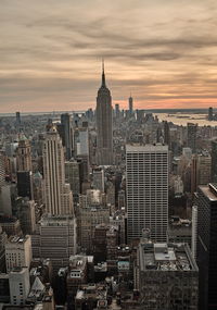 Aerial view of buildings in city at sunset