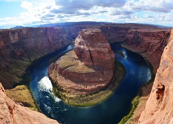 Aerial view of rock formations in river against cloudy sky