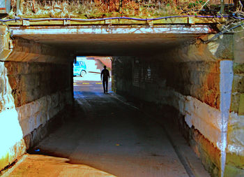 Rear view of silhouette man walking in corridor