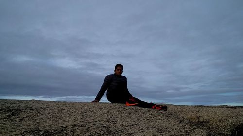 Full length of young man on land against sky