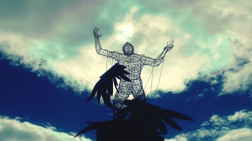 Low angle view of statue against sky