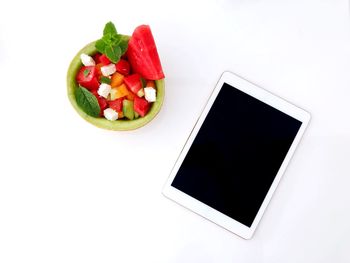 High angle view of fruit salad in plate against white background