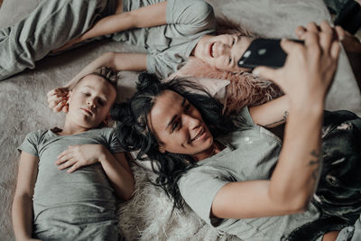 High angle view of woman relaxing on bed at home