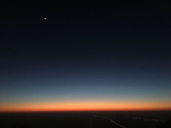 Scenic view of landscape against clear sky at night