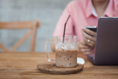 Midsection of coffee cup on table