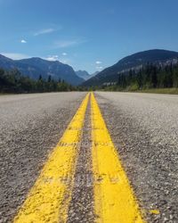 Empty road leading towards mountains