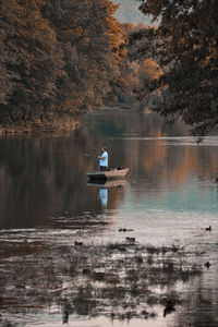 Man sitting on boat in lake