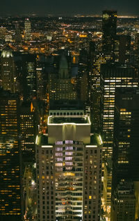 Aerial view of illuminated buildings in city at night
