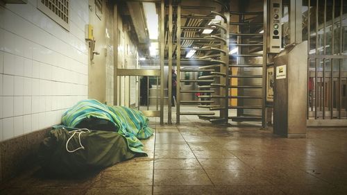 Homeless man sleeping in underground walkway