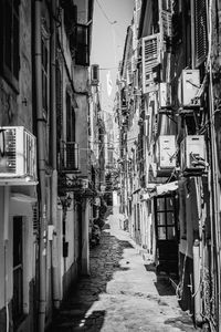 Walkway amidst buildings in city