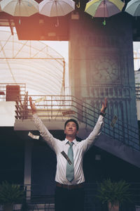 Full length of young man standing in front of building