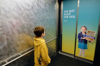 Boy standing against wall