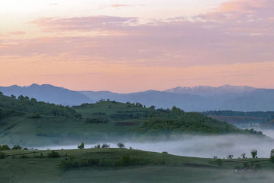 Scenic view of field against sky during sunset