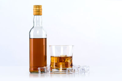 Close-up of beer glass bottle against white background