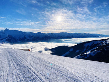 Scenic view of snow covered mountains against sky