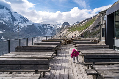 Girl by mountains at restaurant during winter