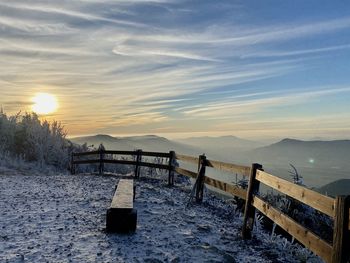 Scenic view of snow covered mountains against sky during sunset