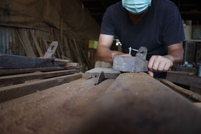 Man working on wood in workshop