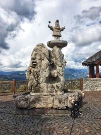 Statue of historical building against cloudy sky