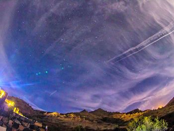 Scenic view of mountains against sky at night