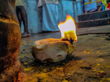 Close-up of lit candles on rock